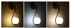 Aplique de pared Selene de vidrio opal, en un ambiente residencial acogedor