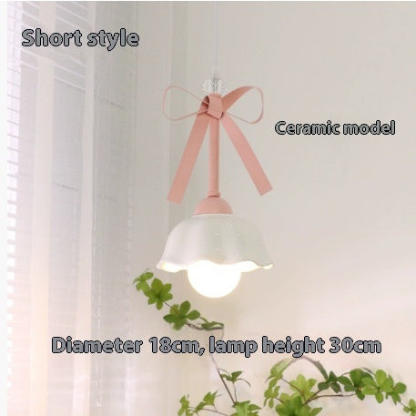 Lámpara colgante Lazo de estilo cream, encendida creando luz cálida