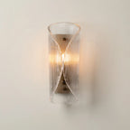 Aplique de pared Rizo de vidrio y acero, encendida creando luz cálida